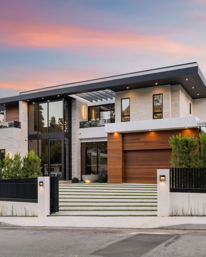 Modern luxury house exterior at sunset with contemporary design and landscaped front yard.